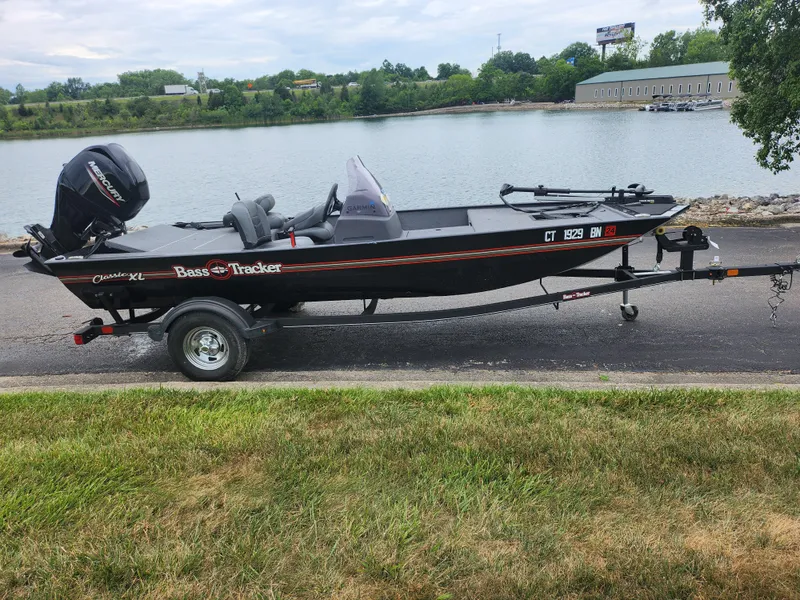 Slide: The Image of 2021 Tracker Bass Tracker Classic XL boat on trailer by a lake. - 10