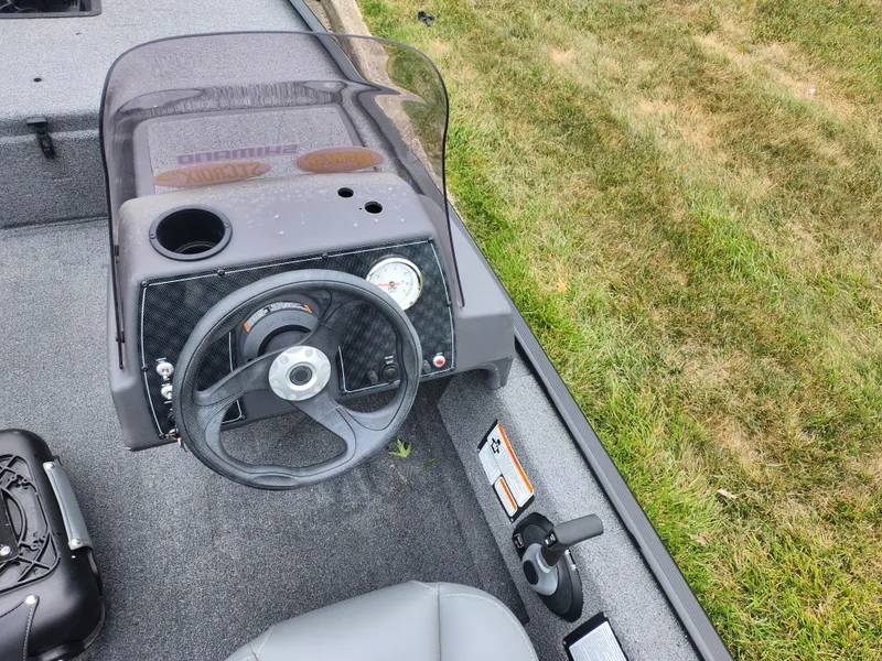 Slide: The Image of 2021 Tracker Bass Tracker Classic XL boat dashboard and steering wheel. - 12