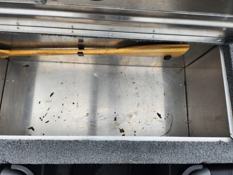 Slide: The Image of 2021 Tracker Bass Tracker Classic XL storage compartment with paddle. - 21