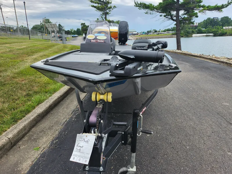 Slide: The Image of 2021 Tracker Bass Tracker Classic XL boat on trailer near a lake. - 7