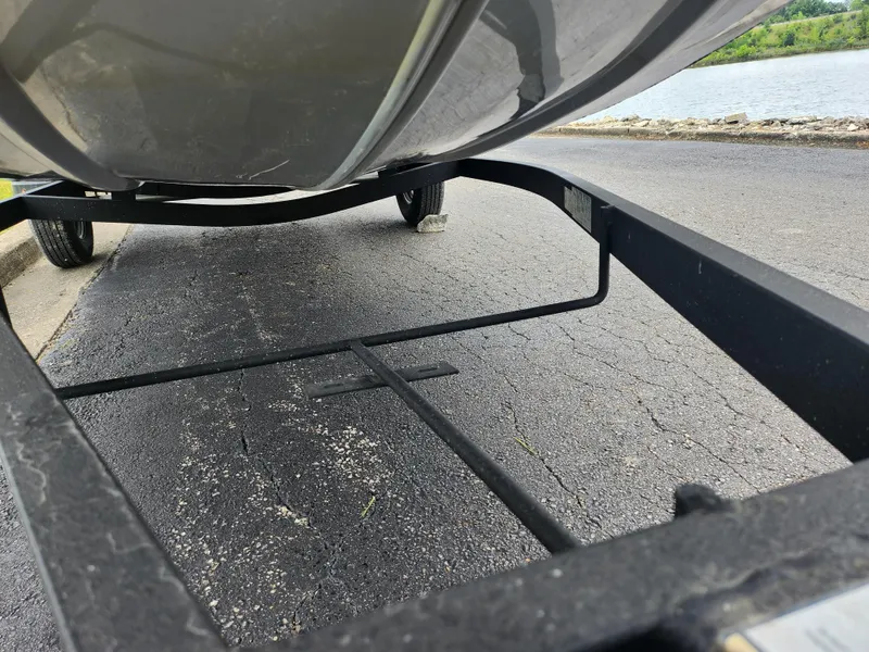 Slide: The Image of 2021 Tracker Bass Tracker Classic XL on a boat trailer near a lake. - 8