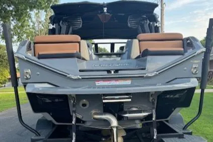 Slide: The Image of 2020 Nautique P23 boat rear view with seating and engine details. - 11
