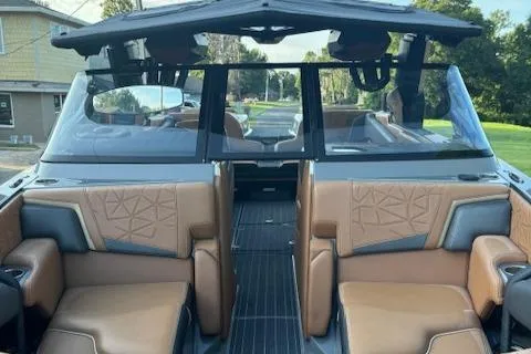 Slide: The Image of 2020 Nautique P23 boat interior with tan leather seats and modern design. - 12