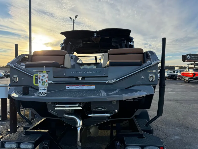 Slide: The Image of 2020 Nautique P23 boat on trailer at sunset, rear view. - 5