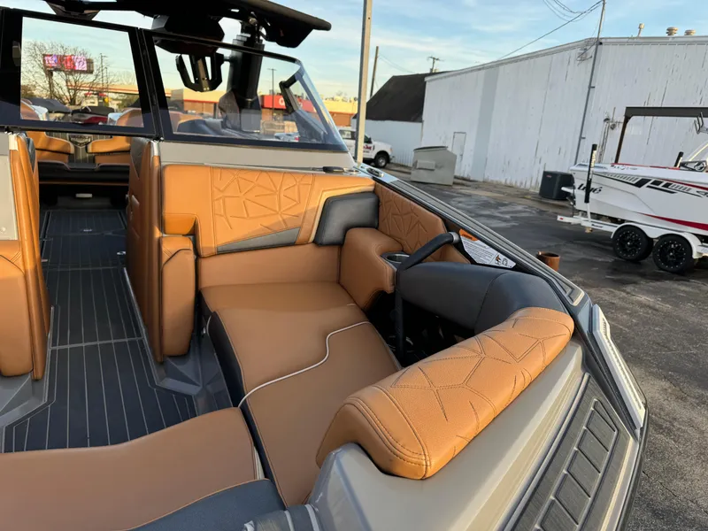 Slide: The Image of 2020 Nautique P23 boat interior with tan leather seating and modern design. - 6