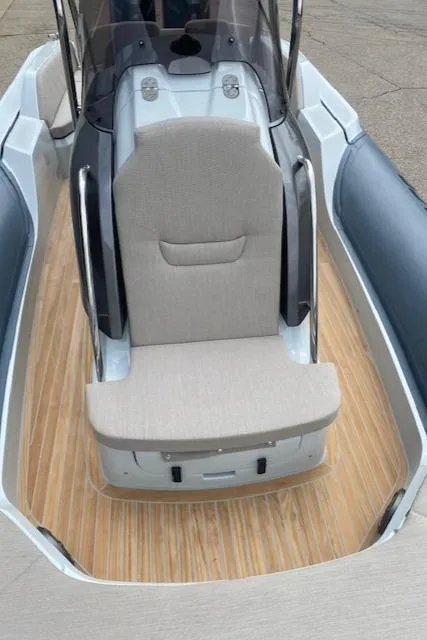 Slide: The Image of 2024 SACS Strider 900 boat with cushioned seating and sleek design. - 10