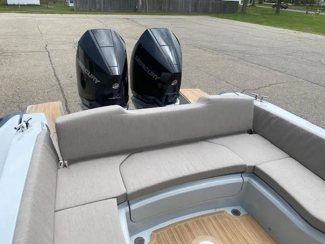 Slide: The Image of 2024 SACS Strider 900 boat with twin Mercury outboard engines and cushioned seating. - 2