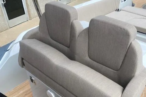 Slide: The Image of 2024 SACS Strider 900 boat with beige cushioned seating. - 4