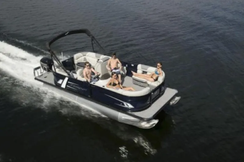 Slide: The Image of 2025 Starcraft EXS 1 pontoon boat cruising with passengers on a lake. - 11