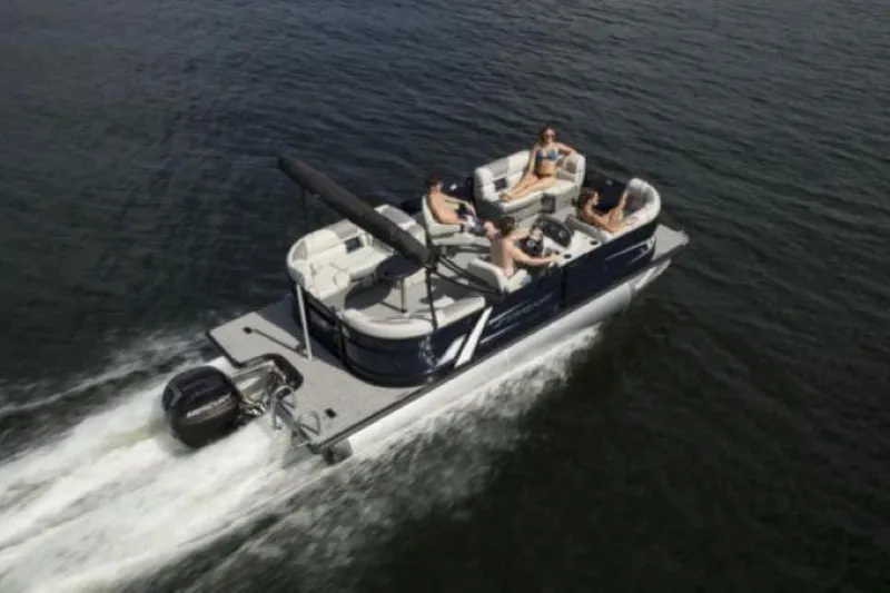 Slide: The Image of 2025 Starcraft EXS 1 pontoon boat cruising on water with passengers relaxing. - 12