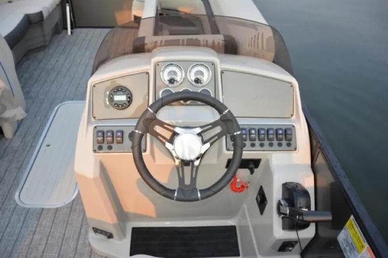 Slide: The Image of 2025 Starcraft EXS 1 boat dashboard with steering wheel and control panel. - 15