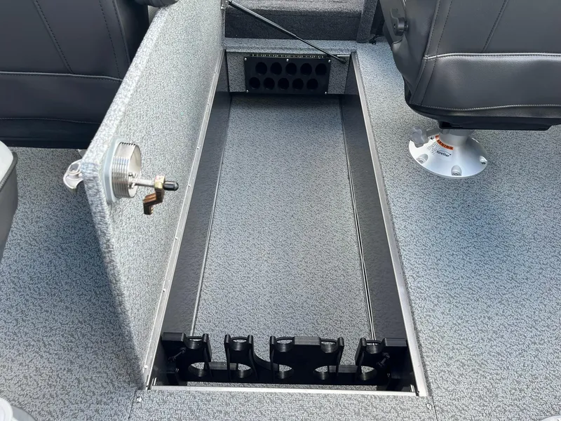 Slide: The Image of 2025 Lund 1975 Tyee boat interior storage compartment with rod holders. - 12