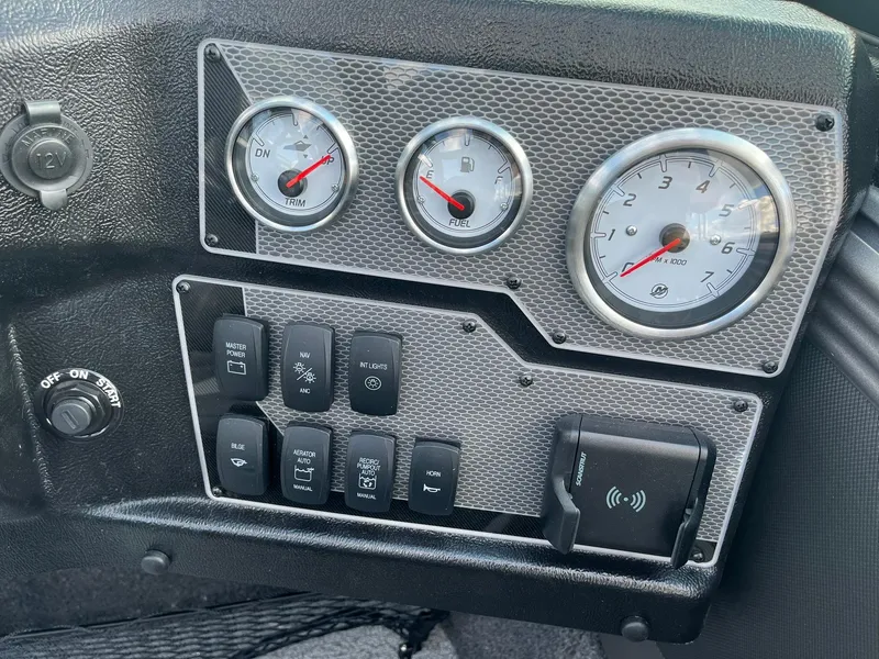 Slide: The Image of Dashboard of a 2025 Lund 1975 Tyee boat with gauges and switches. - 15