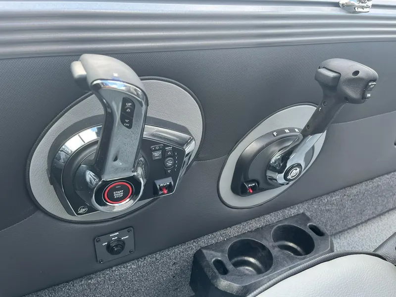Slide: The Image of 2025 Lund 1975 Tyee boat controls and cup holders. - 16