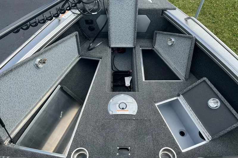 Slide: The Image of 2025 Lund 1975 Tyee boat interior with open storage compartments. - 18