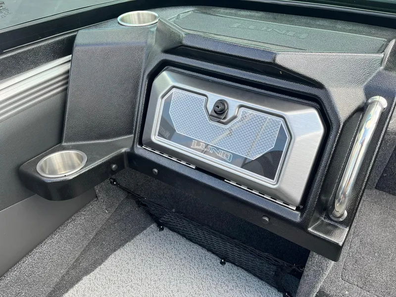 Slide: The Image of 2025 Lund 1975 Tyee boat interior with storage compartment and cup holders. - 22