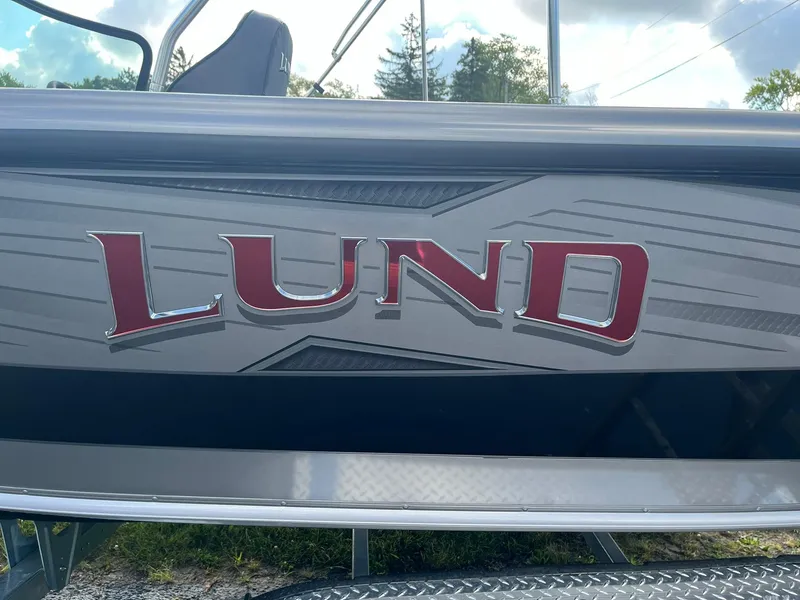 Slide: The Image of 2025 Lund 1975 Tyee boat with red logo on the side. - 25