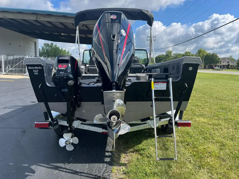 Slide: The Image of 2025 Lund 1975 Tyee boat rear view with dual outboard motors and ladder. - 3