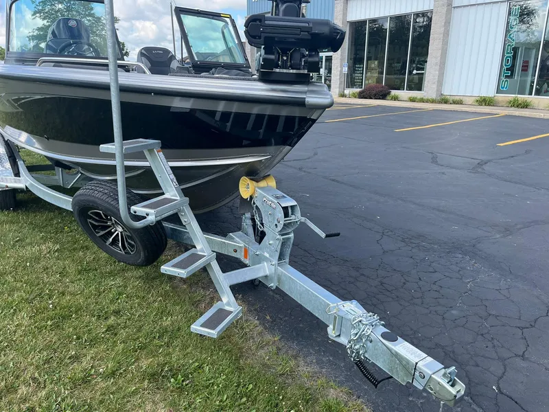 Slide: The Image of 2025 Lund 1975 Tyee boat on trailer in parking lot. - 4