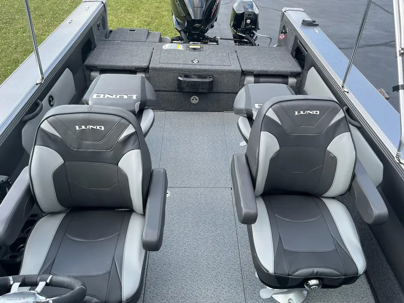 Slide: The Image of 2025 Lund 1975 Tyee boat interior with dual seats and motor. - 7