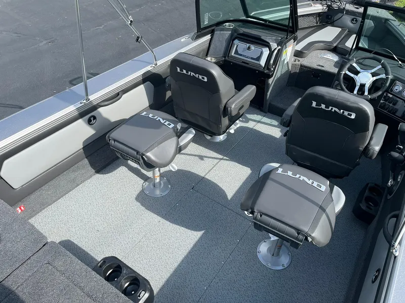 Slide: The Image of 2025 Lund 1975 Tyee boat interior with four seats and modern dashboard. - 8