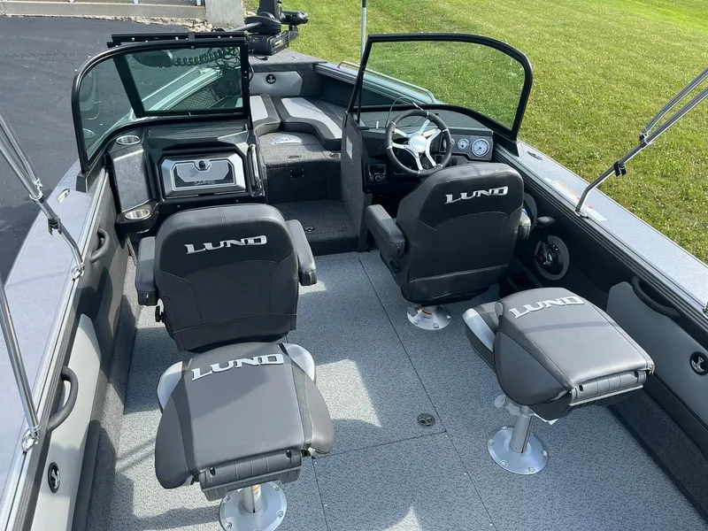 Slide: The Image of 2025 Lund 1975 Tyee boat interior with seating and steering console. - 9