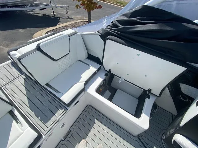 Slide: The Image of 2024 Yamaha Boats 252SD interior with white seating and storage compartment. - 11