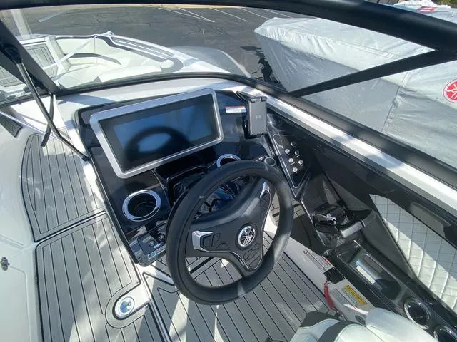 Slide: The Image of 2024 Yamaha Boats 252SD cockpit with modern steering and touchscreen display. - 15
