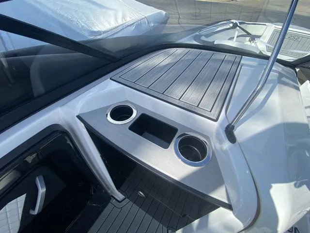 Slide: The Image of 2024 Yamaha Boats 252SD interior with cup holders and sleek design. - 19