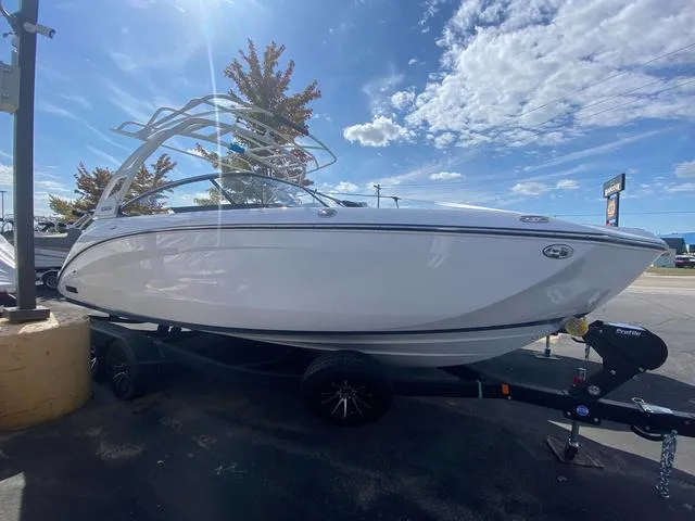 Slide: The Image of 2024 Yamaha Boats 252SD on trailer under clear blue sky. - 2