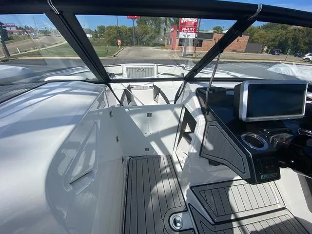 Slide: The Image of 2024 Yamaha Boats 252SD interior with modern dashboard and spacious seating. - 21