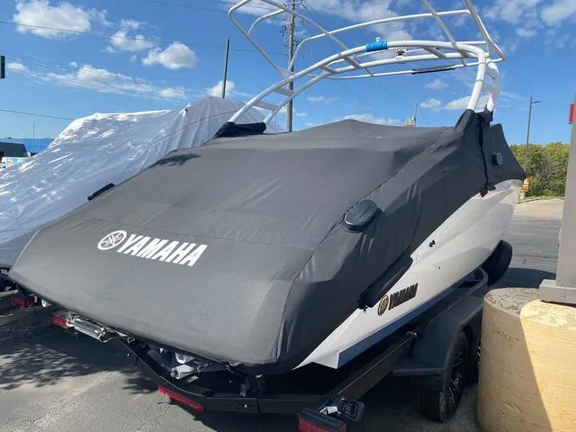 Slide: The Image of 2024 Yamaha Boats 252SD covered, on trailer, under clear blue sky. - 25
