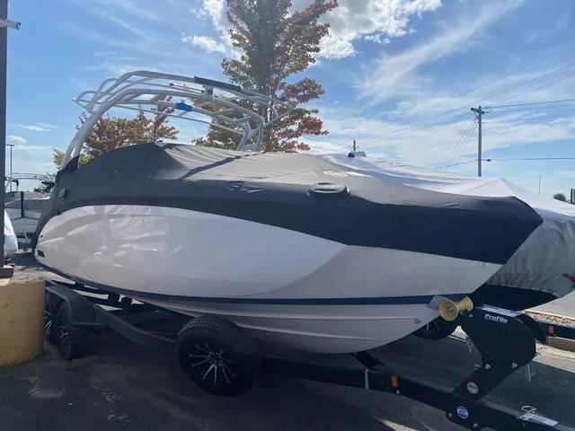 Slide: The Image of 2024 Yamaha Boats 252SD covered on trailer, outdoor display. - 26