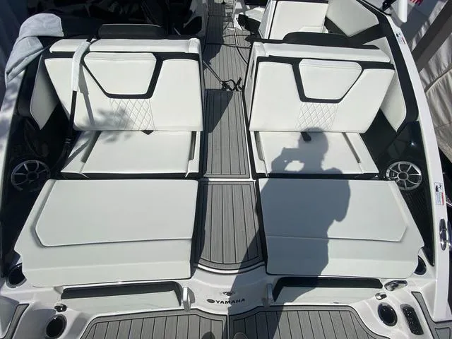 Slide: The Image of 2024 Yamaha Boats 252SD interior seating, white upholstery, modern design. - 5