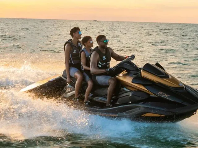 Slide: The Image of Three people riding a 2024 Yamaha Waverunner FX Limited SVHO with Audio System on the ocean at sunset. - 6