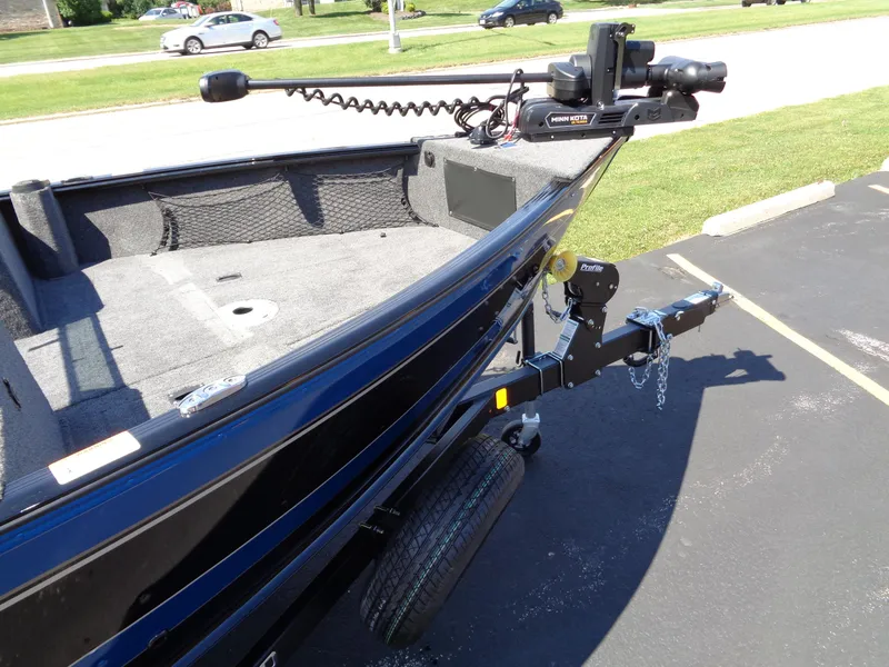 Slide: The Image of 2024 Lund 1875 Impact XS fishing boat on trailer, close-up of bow and trolling motor. - 3