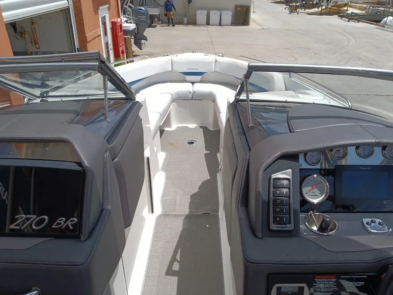 Slide: The Image of 2019 Formula 270 Bowrider boat interior with dashboard and seating area. - 13
