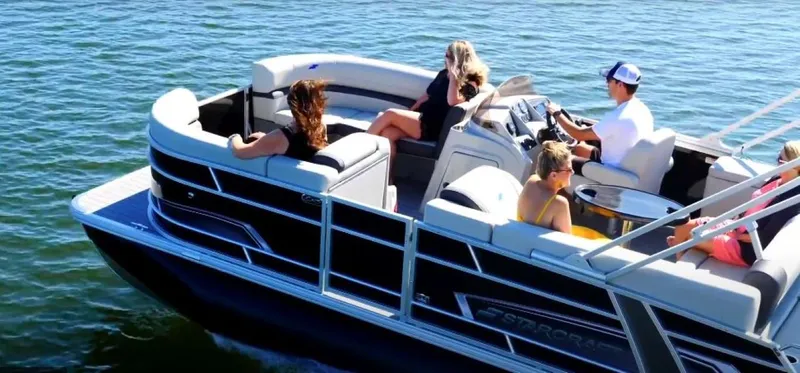 Slide: The Image of 2025 Starcraft EXS 3 Q pontoon boat cruising with passengers on a sunny day. - 4