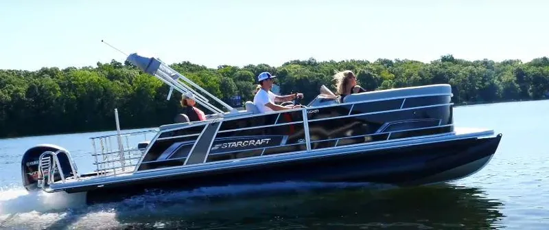 Slide: The Image of 2025 Starcraft EXS 3 Q pontoon boat cruising on a lake with passengers. - 8