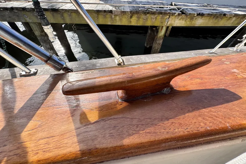 Slide: The Image of Wooden cleat on 1989 Island Packet 35 sailboat deck, near dock. - 13