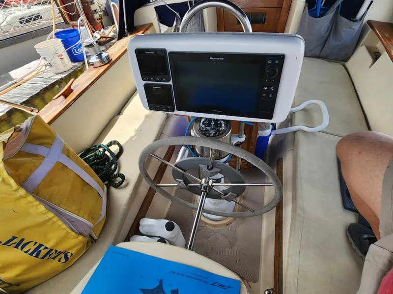 Slide: The Image of 1989 Island Packet 35 sailboat docked, featuring white hull and blue sail cover. - 16