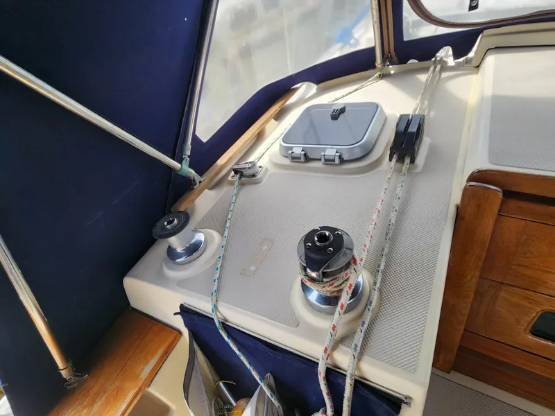 Slide: The Image of Interior of 1989 Island Packet 35 sailboat with cozy seating and navigation area. - 19