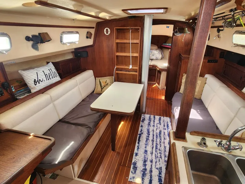 Slide: The Image of 1989 Island Packet 35 sailboat cockpit with wooden hatch and winches. - 21