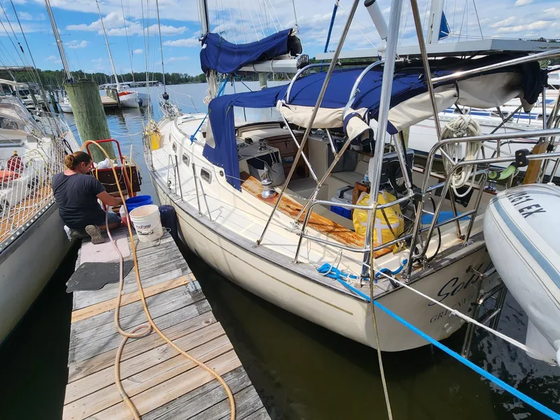 Slide: The Image of 1989 Island Packet 35 sailboat docked at a marina on a sunny day. - 3