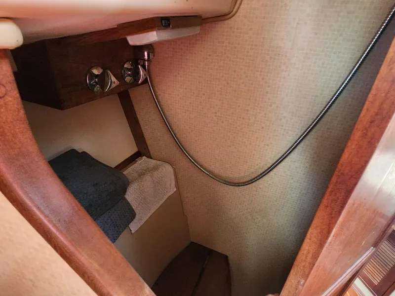 Slide: The Image of Interior of a 1989 Island Packet 35 sailboat with seating area. - 30