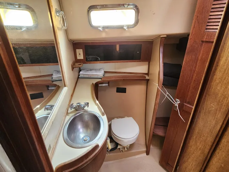 Slide: The Image of Engine compartment of a 1989 Island Packet 35 sailboat, showing mechanical components and labels. - 31