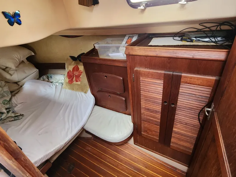 Slide: The Image of 1989 Island Packet 35 sailboat cockpit with NavPod, wooden console, and seating. - 32