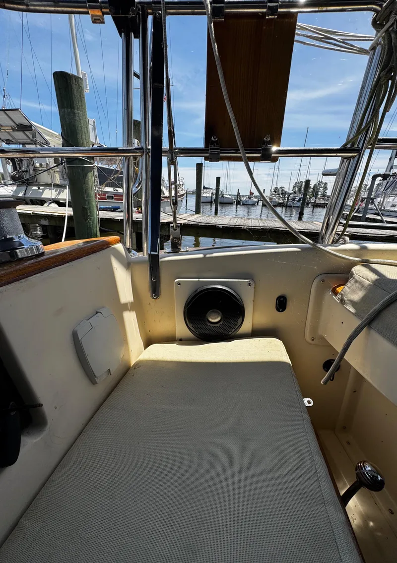 Slide: The Image of 1989 Island Packet 35 sailboat deck with blue and yellow equipment, docked at marina. - 47