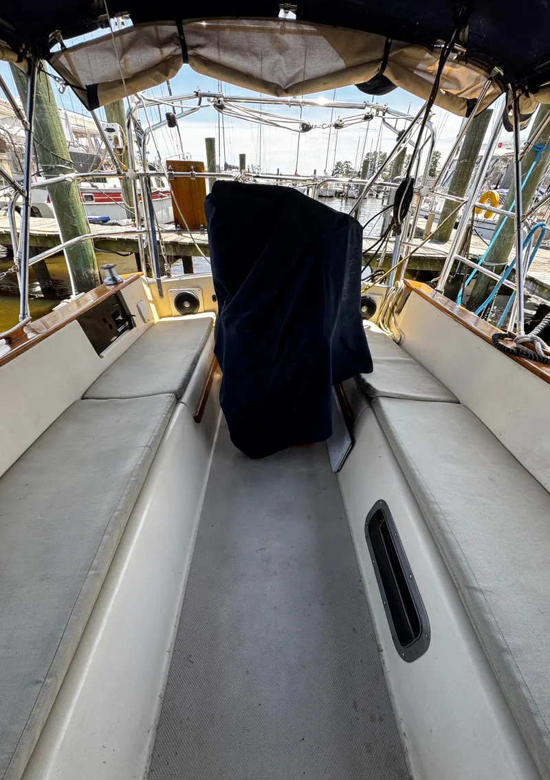 Slide: The Image of 1989 Island Packet 35 sailboat deck with rigging and blue ropes in marina setting. - 49