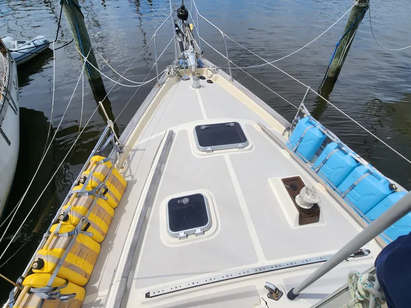 Slide: The Image of 1989 Island Packet 35 sailboat deck with rigging and yellow fuel containers. - 5